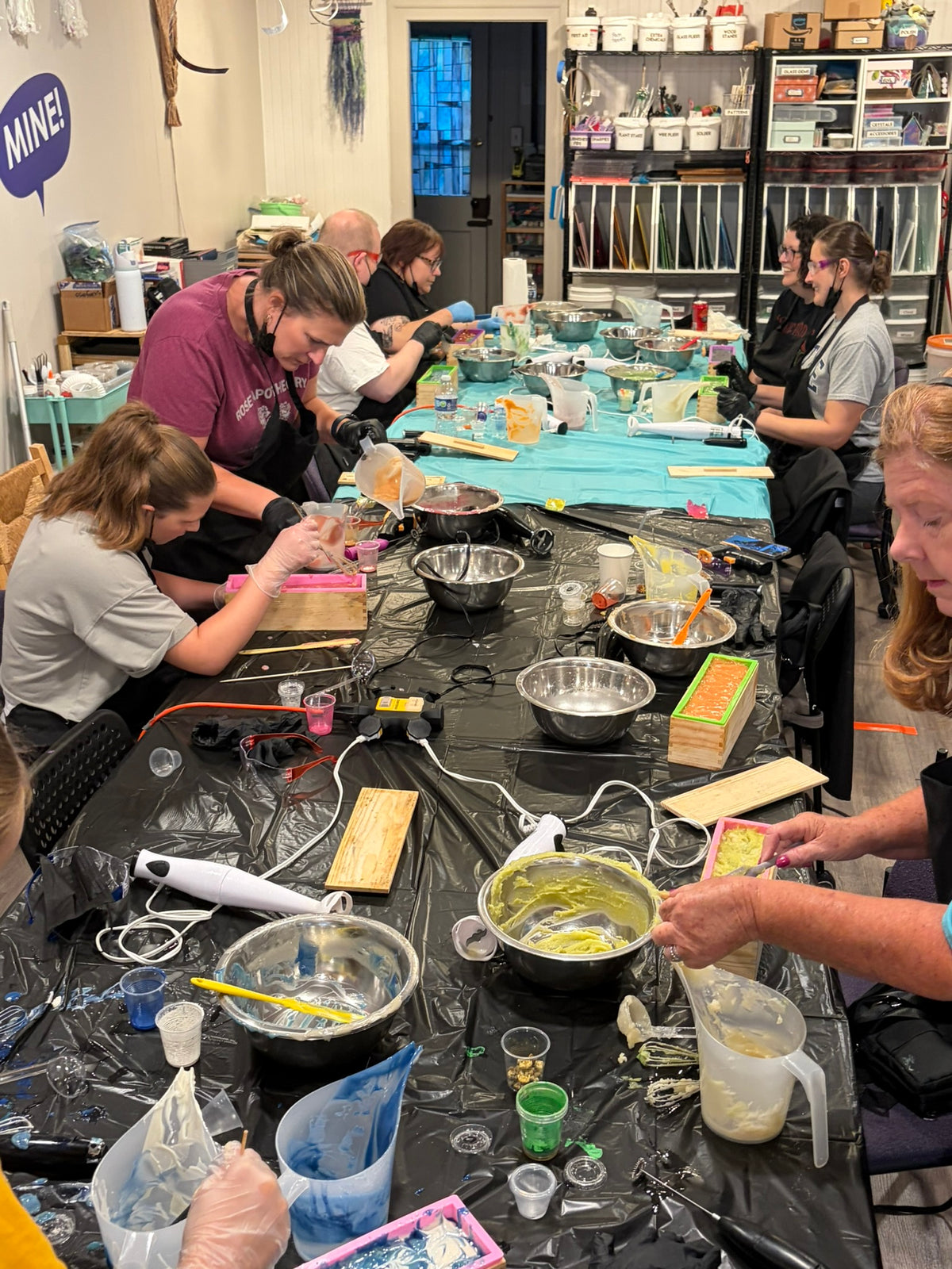 Guests pouring colorful soap loaves together at a Figaro Forge workshop