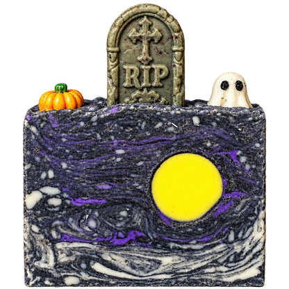 Purple and black graveyard cold-process soap with ghost, tombstone, pumpkin, and moon embeds for a Figaro Forge Halloween workshop